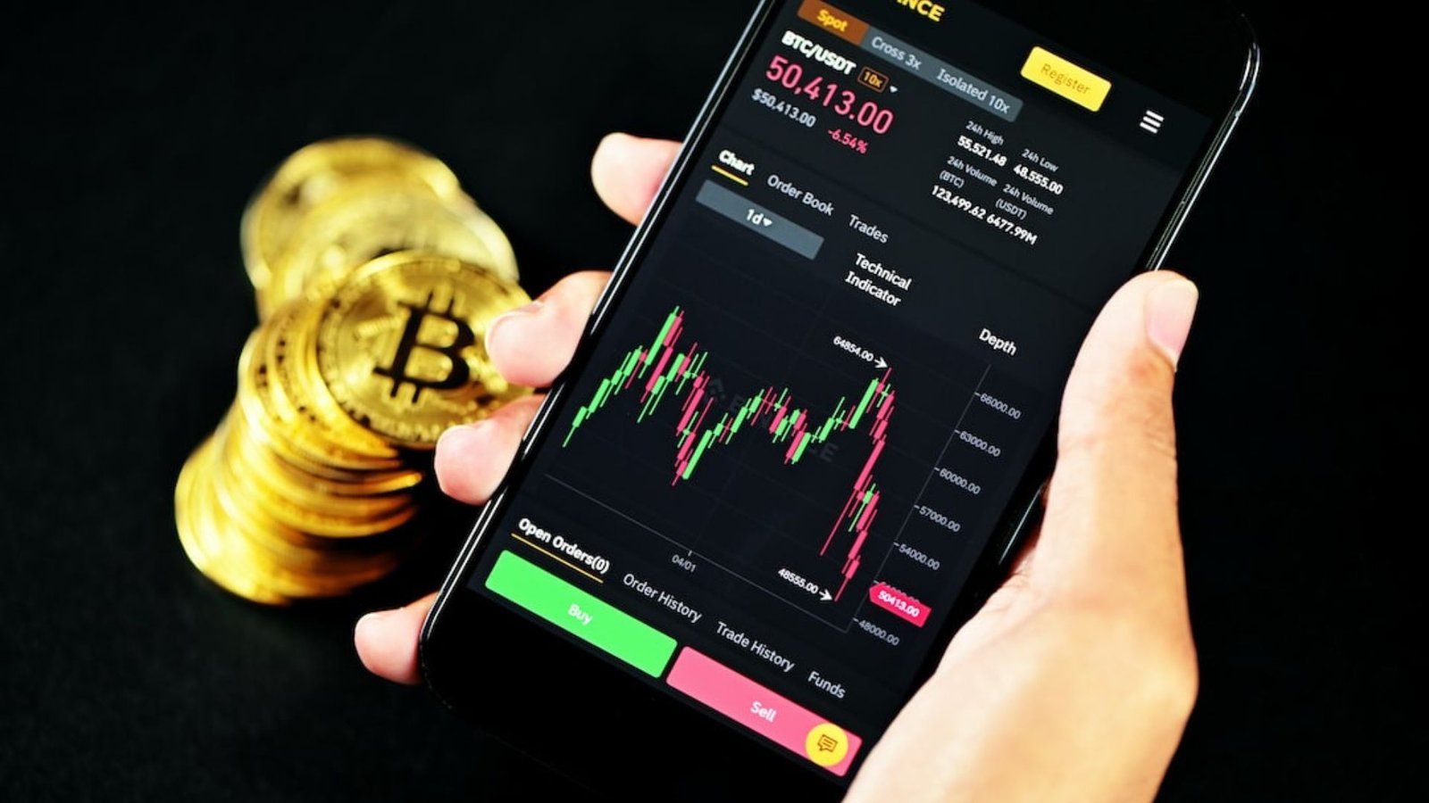 a hand holding a phone showing forex trading app 